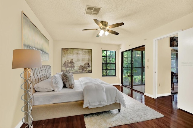 6654 Brambleleaf Dr, Spring Hill, FL 34606 - bedroom featuring access to outside, wood finished floors, a textured ceiling, and ceiling fan