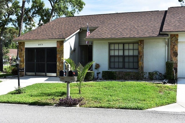 6575 Brambleleaf Dr, Spring Hill, FL 34606 - view of front of home featuring stone siding, a front yard, a shingled roof, and stucco siding