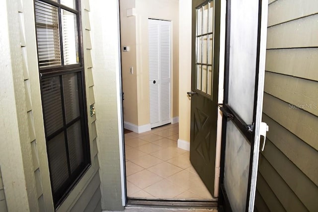 6575 Brambleleaf Dr, Spring Hill, FL 34606 - hallway with light tile patterned floors and baseboards