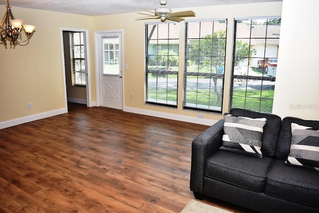 6575 Brambleleaf Dr, Spring Hill, FL 34606 - living room featuring plenty of natural light, a chandelier, a ceiling fan, wood finished floors, and a textured ceiling