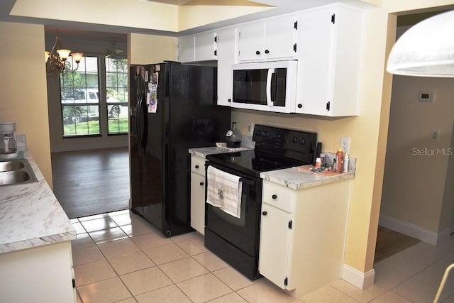 6575 Brambleleaf Dr, Spring Hill, FL 34606 - kitchen with black appliances, a chandelier, light countertops, light tile patterned floors, and white cabinetry