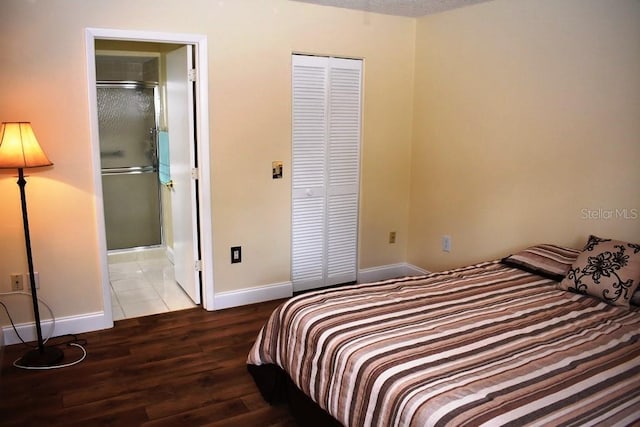 6575 Brambleleaf Dr, Spring Hill, FL 34606 - bedroom with a closet, wood finished floors, and connected bathroom