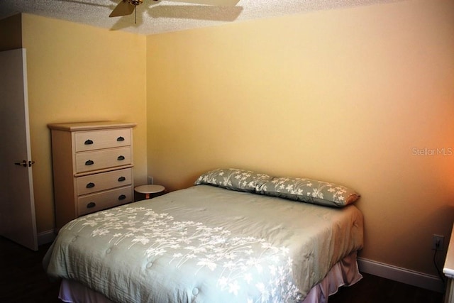 6575 Brambleleaf Dr, Spring Hill, FL 34606 - bedroom featuring dark wood-type flooring, a textured ceiling, and a ceiling fan