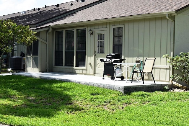 6575 Brambleleaf Dr, Spring Hill, FL 34606 - rear view of property with a shingled roof, a patio, and a lawn