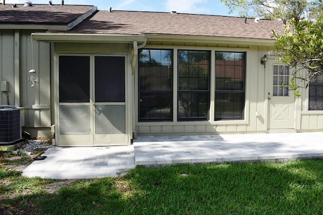 6575 Brambleleaf Dr, Spring Hill, FL 34606 - back of house with roof with shingles, board and batten siding, and a patio area