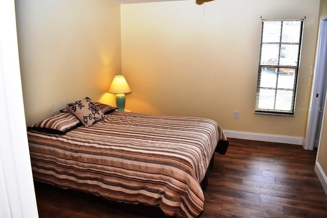 6575 Brambleleaf Dr, Spring Hill, FL 34606 - bedroom featuring baseboards and dark wood-style flooring