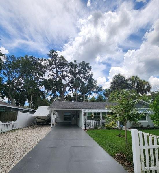 5710 Broadway Ave, New Port Richey, FL 34652 - view of front facade with concrete driveway and an attached carport