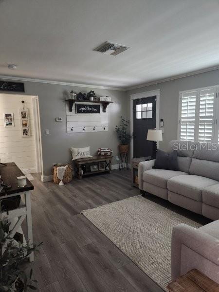 5710 Broadway Ave, New Port Richey, FL 34652 - living area featuring crown molding and wood finished floors