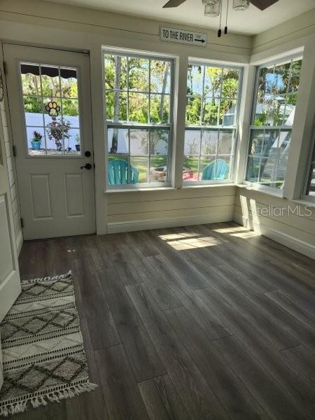 5710 Broadway Ave, New Port Richey, FL 34652 - unfurnished sunroom with wood finished floors