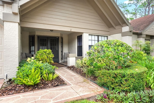 6085 Pekin Ct, Spring Hill, FL 34606 - view of exterior entry with a porch and stucco siding