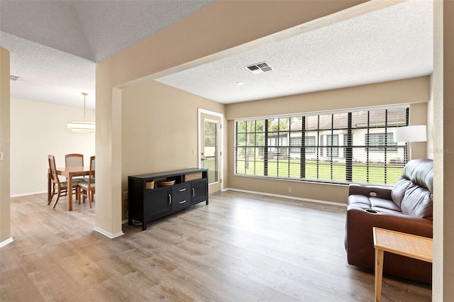 6085 Pekin Ct, Spring Hill, FL 34606 - sitting room with light wood-style floors and a textured ceiling
