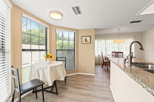 6085 Pekin Ct, Spring Hill, FL 34606 - dining space with light wood finished floors and baseboards