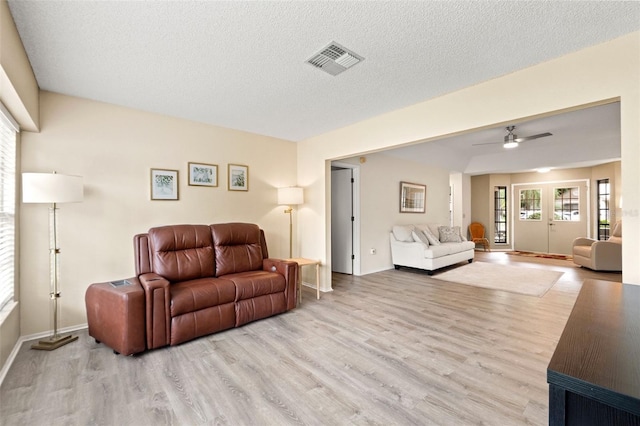 6085 Pekin Ct, Spring Hill, FL 34606 - living room with wood finished floors, ceiling fan, and a textured ceiling