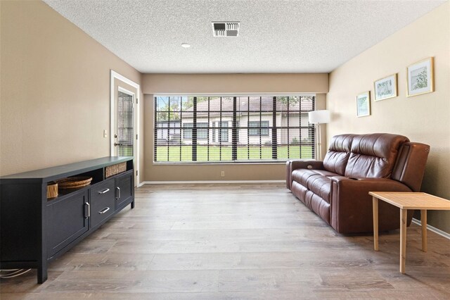 6085 Pekin Ct, Spring Hill, FL 34606 - living area with a textured ceiling and wood finished floors