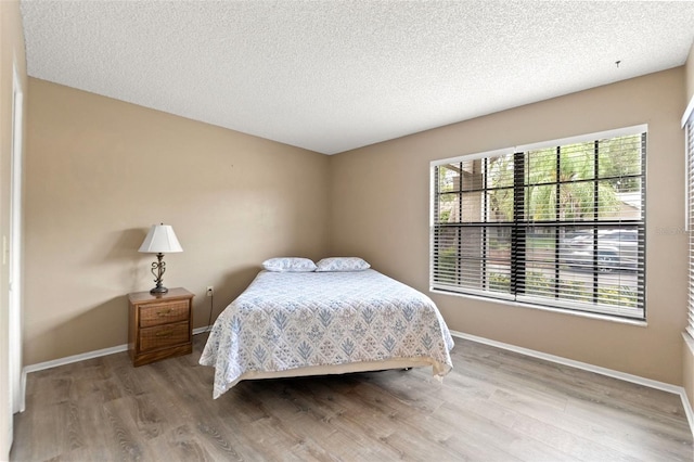 6085 Pekin Ct, Spring Hill, FL 34606 - bedroom with wood finished floors and a textured ceiling