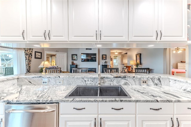 3431 Croaker Dr, Hernando Beach, FL 34607 - kitchen with dishwasher, white cabinets, and light stone counters