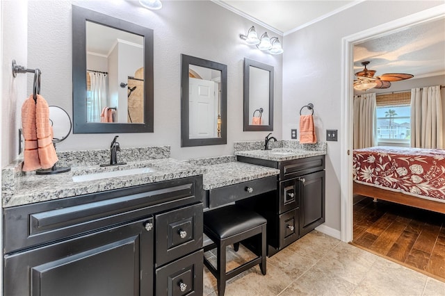 3431 Croaker Dr, Hernando Beach, FL 34607 - full bathroom with ornamental molding, connected bathroom, double vanity, and a ceiling fan