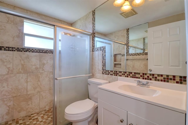 13637 Lagoon Dr, Hudson, FL 34667 - bathroom with tile walls, vanity, a shower stall, and decorative backsplash