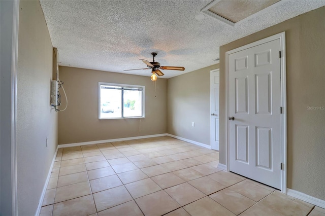 13637 Lagoon Dr, Hudson, FL 34667 - unfurnished room with a textured ceiling, attic access, ceiling fan, and light tile patterned floors