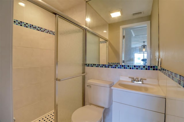 13637 Lagoon Dr, Hudson, FL 34667 - full bathroom with a shower stall, vanity, tile walls, and tasteful backsplash
