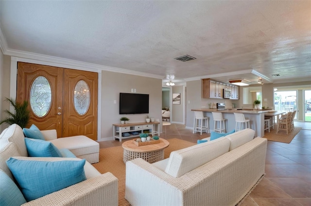 13637 Lagoon Dr, Hudson, FL 34667 - living room featuring crown molding, light tile patterned flooring, and a textured ceiling