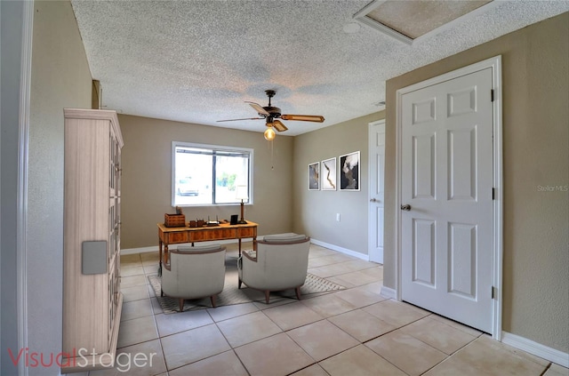 13637 Lagoon Dr, Hudson, FL 34667 - sitting room with a textured ceiling, light tile patterned flooring, ceiling fan, and attic access