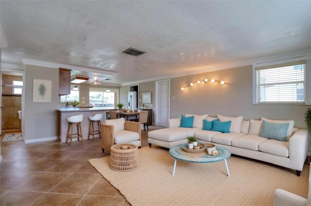 13637 Lagoon Dr, Hudson, FL 34667 - tiled living room with crown molding and a textured ceiling