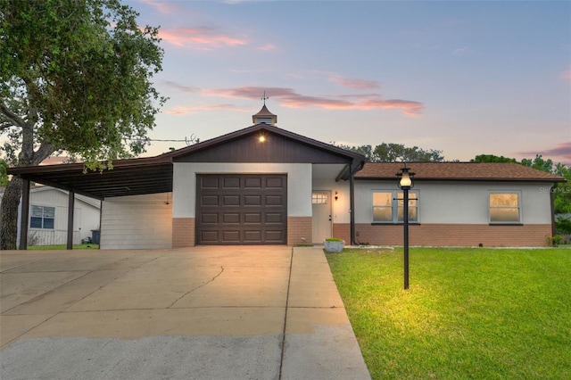 1324 Newhope Rd, Spring Hill, FL 34606 - view of front of property with brick siding, concrete driveway, a lawn, an attached carport, and a garage