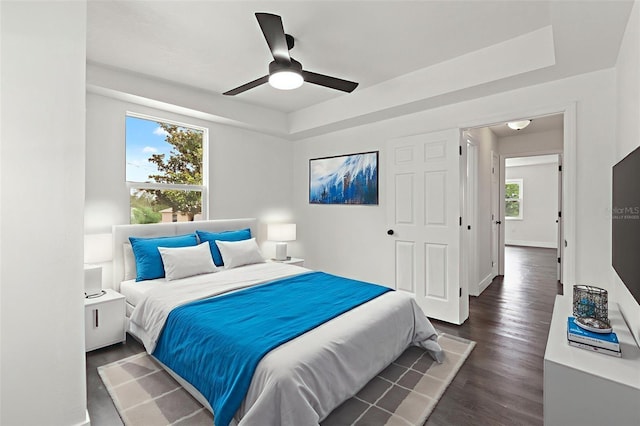 1324 Newhope Rd, Spring Hill, FL 34606 - bedroom featuring dark wood-type flooring, a raised ceiling, and ceiling fan