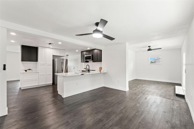 1324 Newhope Rd, Spring Hill, FL 34606 - kitchen with appliances with stainless steel finishes, ceiling fan, light countertops, a peninsula, and open floor plan