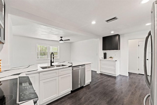 1324 Newhope Rd, Spring Hill, FL 34606 - kitchen with appliances with stainless steel finishes, light stone countertops, recessed lighting, dark wood finished floors, and ceiling fan