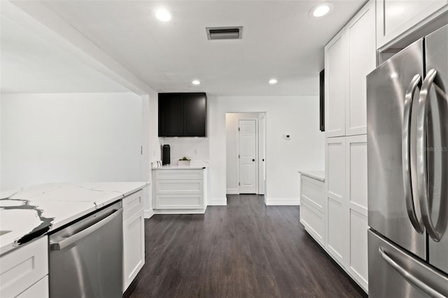 1324 Newhope Rd, Spring Hill, FL 34606 - kitchen with stainless steel appliances, light stone counters, recessed lighting, white cabinets, and dark wood-style flooring