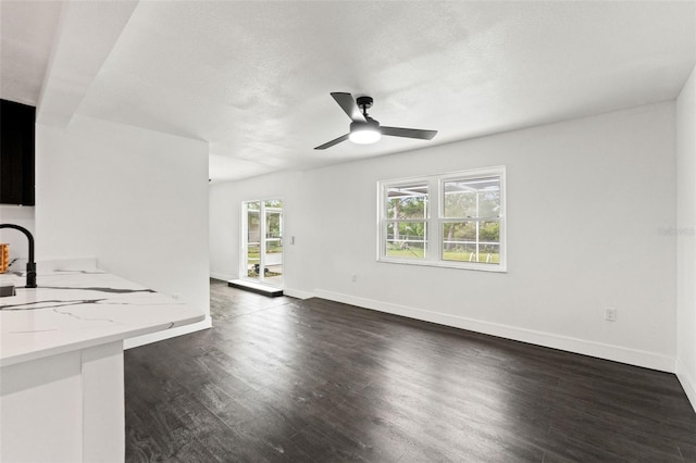 1324 Newhope Rd, Spring Hill, FL 34606 - unfurnished living room featuring dark wood finished floors, ceiling fan, and a textured ceiling