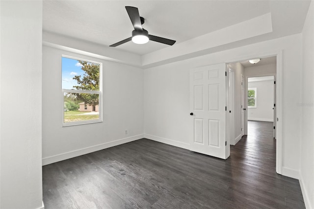 1324 Newhope Rd, Spring Hill, FL 34606 - spare room with dark wood-style floors, ceiling fan, and a raised ceiling