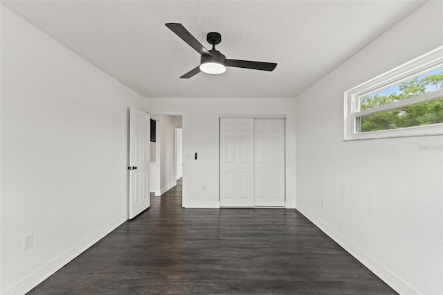 1324 Newhope Rd, Spring Hill, FL 34606 - unfurnished bedroom with dark wood-style flooring, a closet, and a ceiling fan