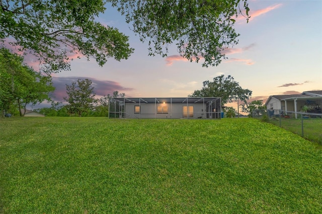 1324 Newhope Rd, Spring Hill, FL 34606 - yard at dusk featuring a lanai