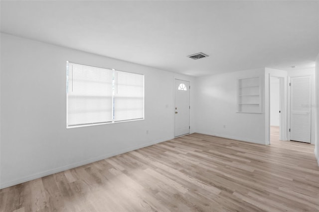 3528 Sheryl Hill Dr, Holiday, FL 34691 - empty room with light wood-style floors and built in features