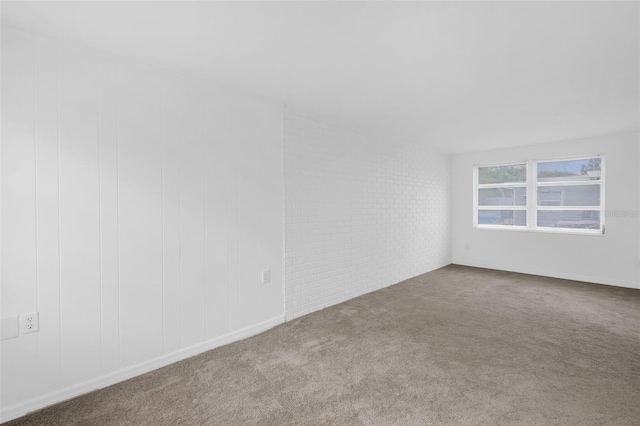 3528 Sheryl Hill Dr, Holiday, FL 34691 - spare room with carpet flooring and brick wall