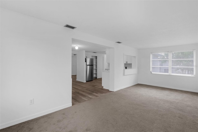 3528 Sheryl Hill Dr, Holiday, FL 34691 - unfurnished living room with carpet floors and baseboards