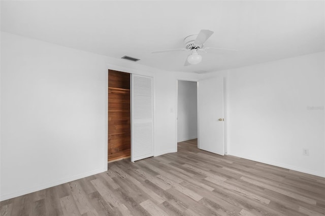 3528 Sheryl Hill Dr, Holiday, FL 34691 - unfurnished bedroom with wood finished floors, a closet, and a ceiling fan