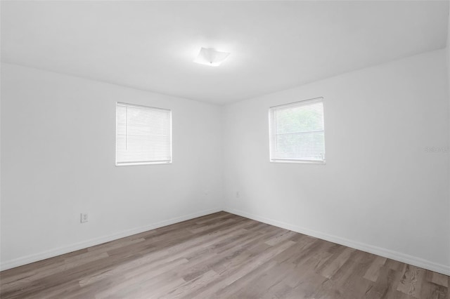 3528 Sheryl Hill Dr, Holiday, FL 34691 - empty room featuring wood finished floors and baseboards