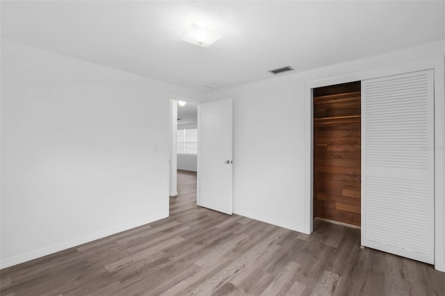 3528 Sheryl Hill Dr, Holiday, FL 34691 - unfurnished bedroom with wood finished floors and a closet