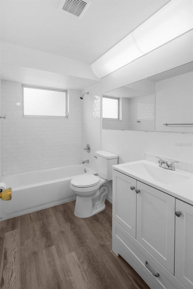 3528 Sheryl Hill Dr, Holiday, FL 34691 - full bathroom with vanity, shower / bath combination, wood finished floors, and healthy amount of natural light