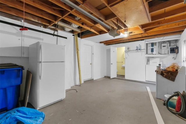 3528 Sheryl Hill Dr, Holiday, FL 34691 - unfinished basement featuring freestanding refrigerator and washer / dryer