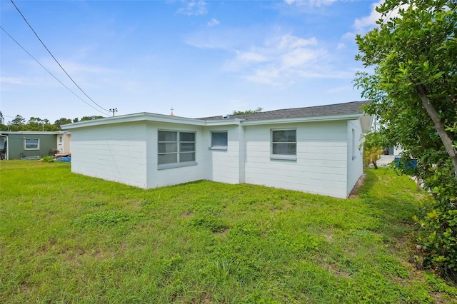 3528 Sheryl Hill Dr, Holiday, FL 34691 - rear view of house featuring a lawn