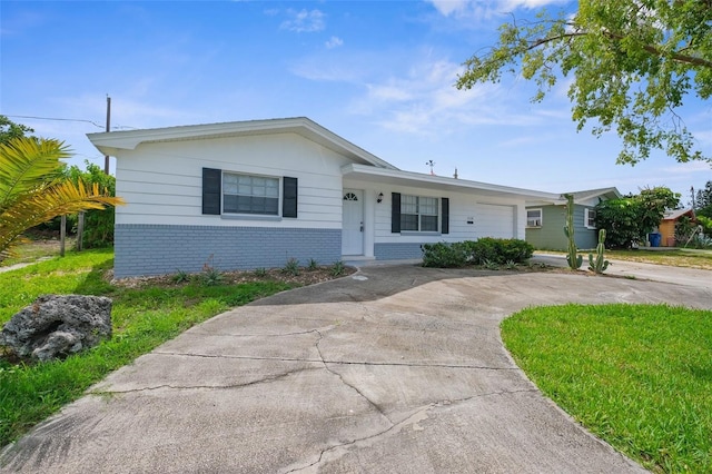 3528 Sheryl Hill Dr, Holiday, FL 34691 - view of front of home with brick siding, concrete driveway, and an attached garage