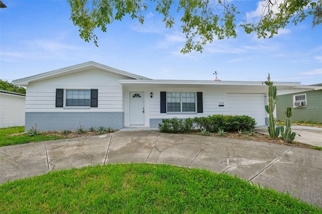 3528 Sheryl Hill Dr, Holiday, FL 34691 - single story home with brick siding, concrete driveway, and cooling unit