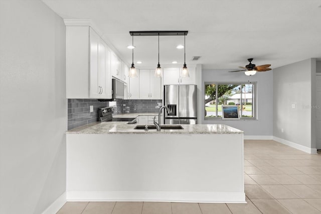 11446 W Bayshore Dr Unit 36, Crystal River, FL 34429 - kitchen with stainless steel appliances, a peninsula, backsplash, light stone counters, and ceiling fan