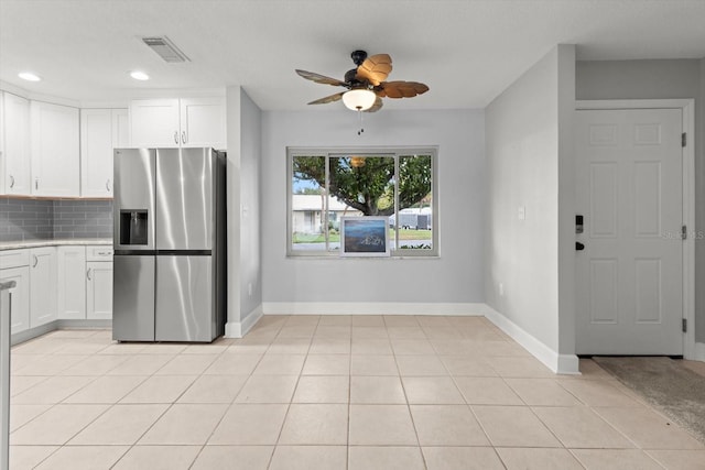 11446 W Bayshore Dr Unit 36, Crystal River, FL 34429 - kitchen with stainless steel refrigerator with ice dispenser, a ceiling fan, light countertops, backsplash, and white cabinets