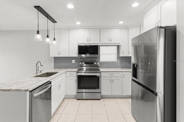 11446 W Bayshore Dr Unit 36, Crystal River, FL 34429 - kitchen with stainless steel appliances, a peninsula, backsplash, recessed lighting, and white cabinetry